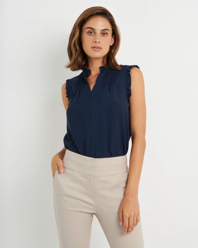 Forcast Clothing, the Aya Frill Neck Blouse features unique vertical pleat details, and ruffles on neckline and shoulder