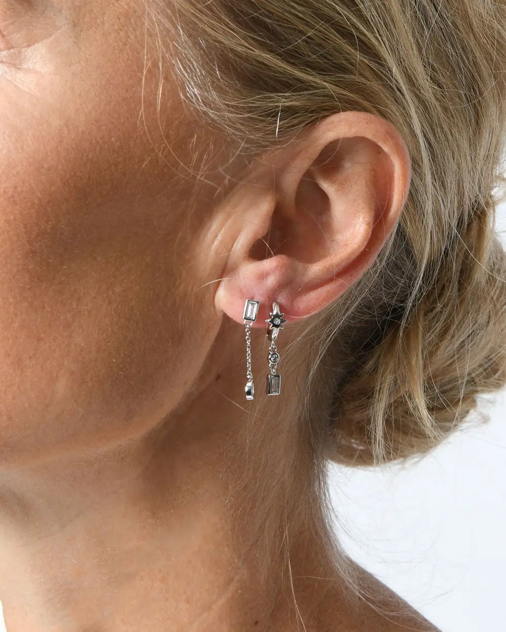 Forcast Clothing, the Diya Sterling Silver Plated 2pc Earring Set, with a Cubic Zirconia Stone stud and chain, alongside small huggie hoops.